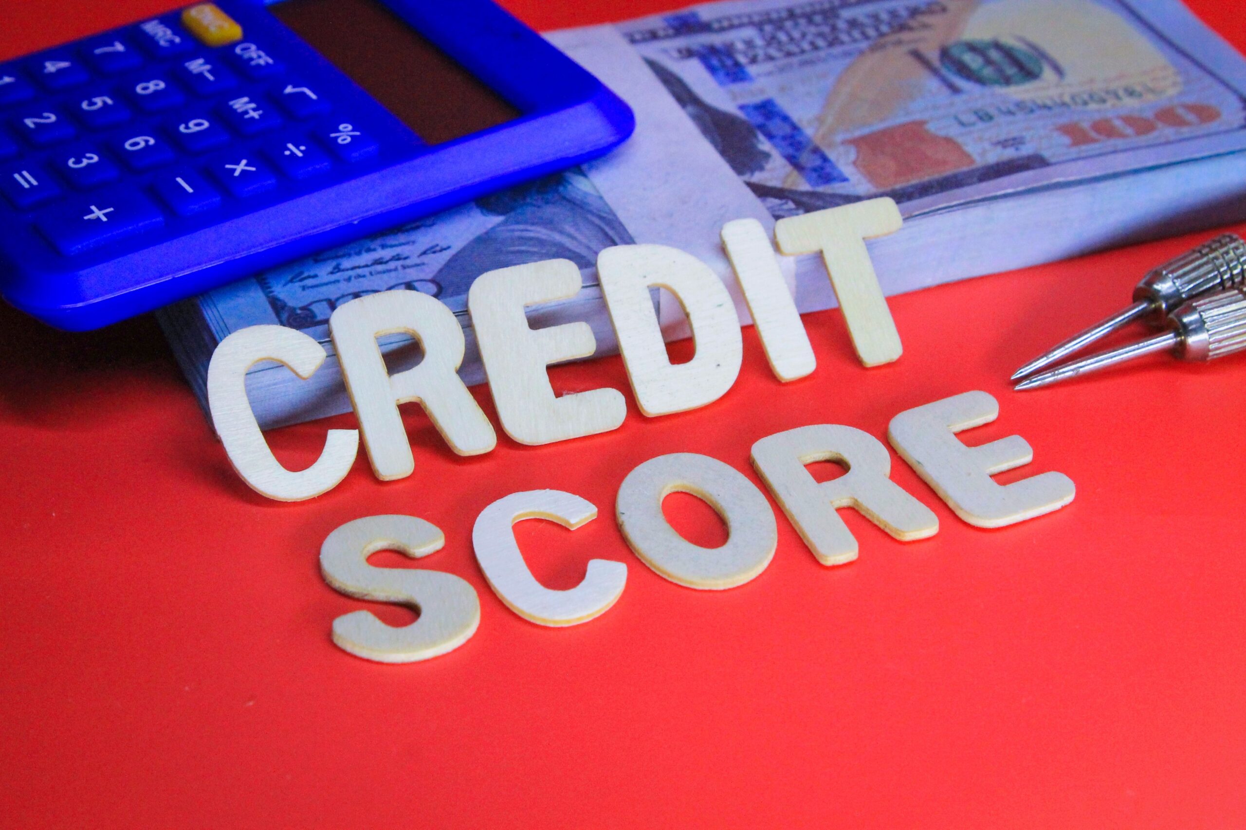 calculator and paper money with the word credit score. business concept